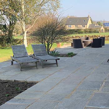 Stone patio in back garden of a country house